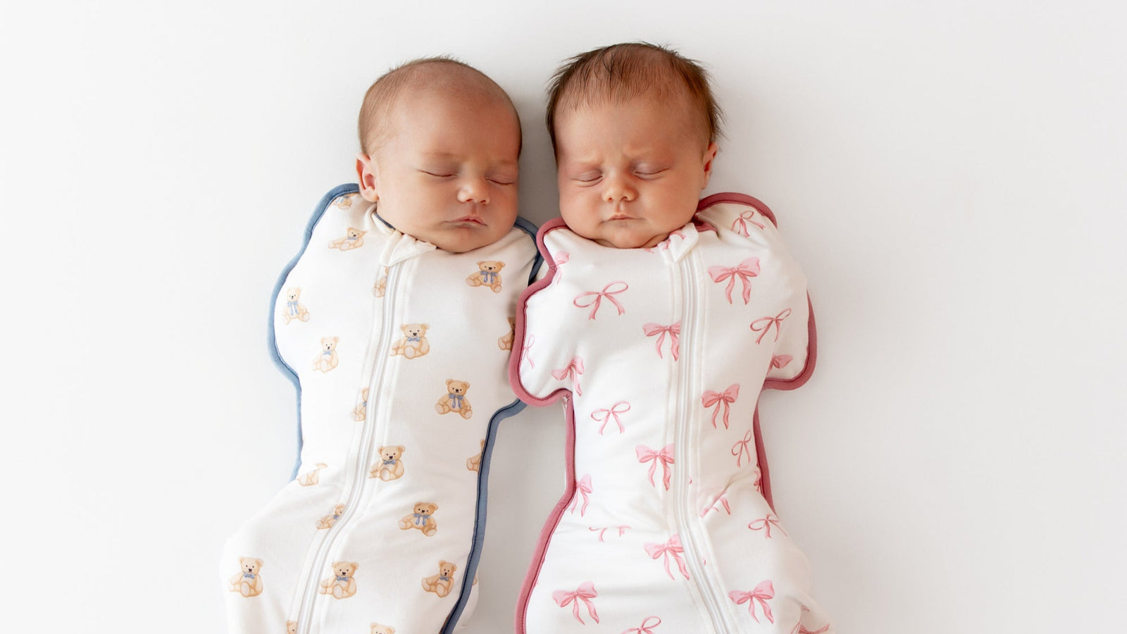 Two babies wrapped in swaddle bags